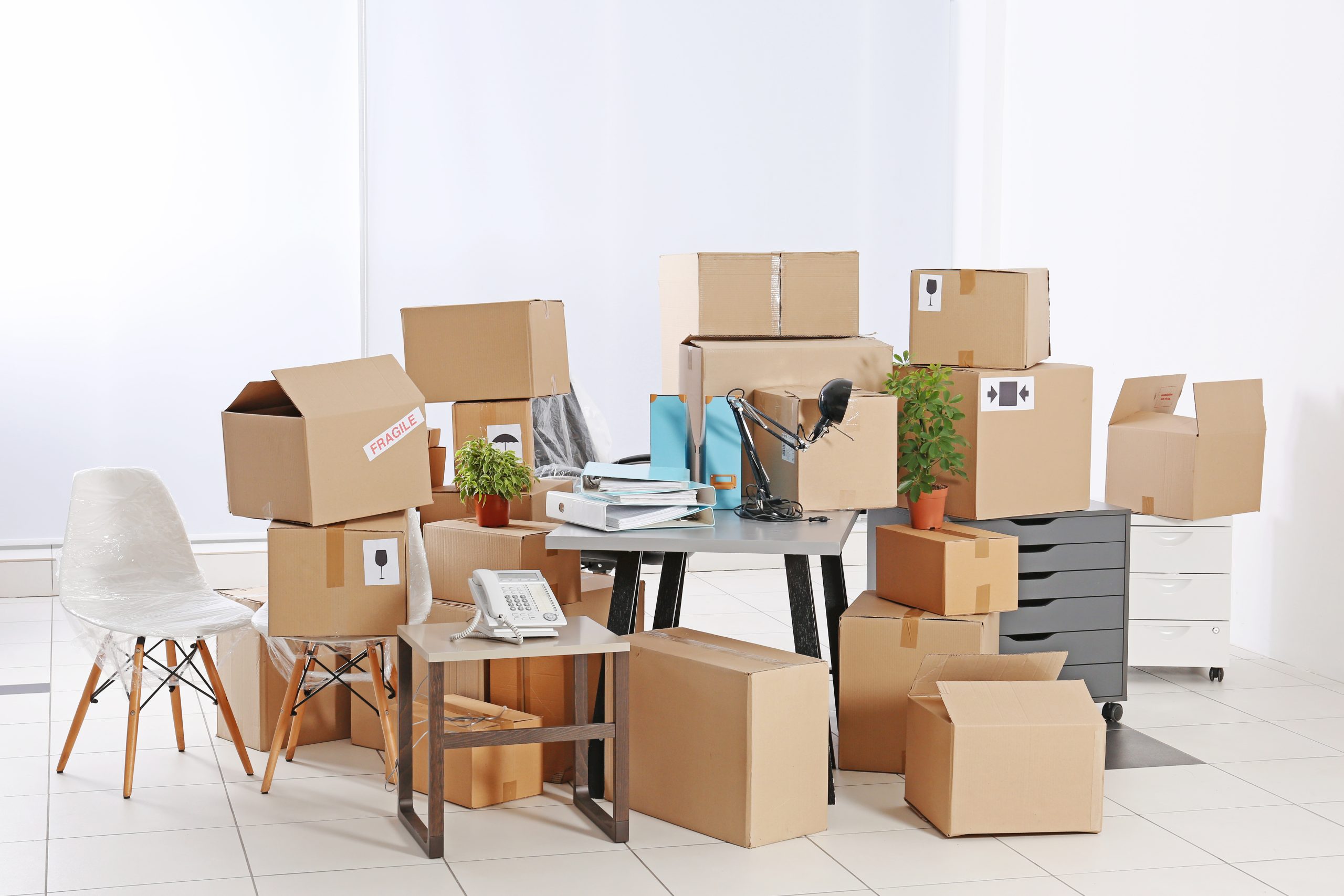 Move concept. Unpacking cardboard boxes in a new office