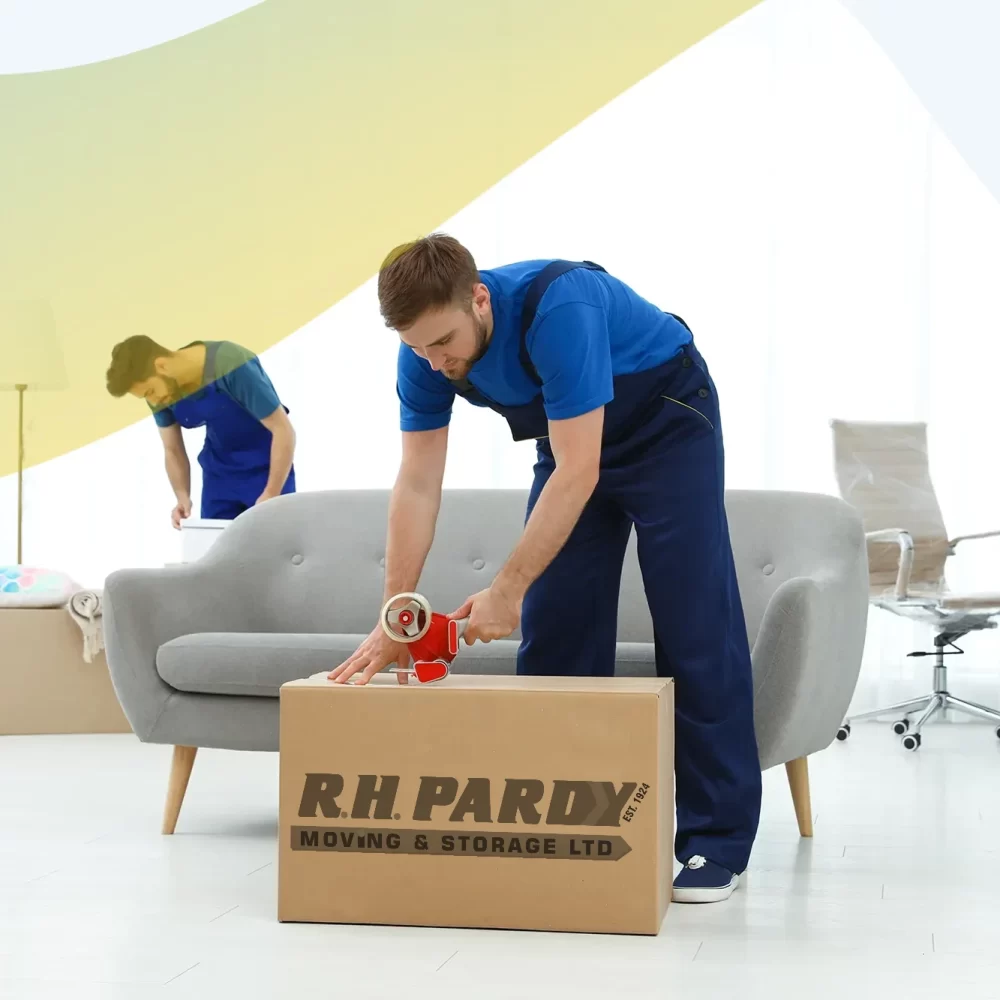 Removals company workers helping a family pack for the move