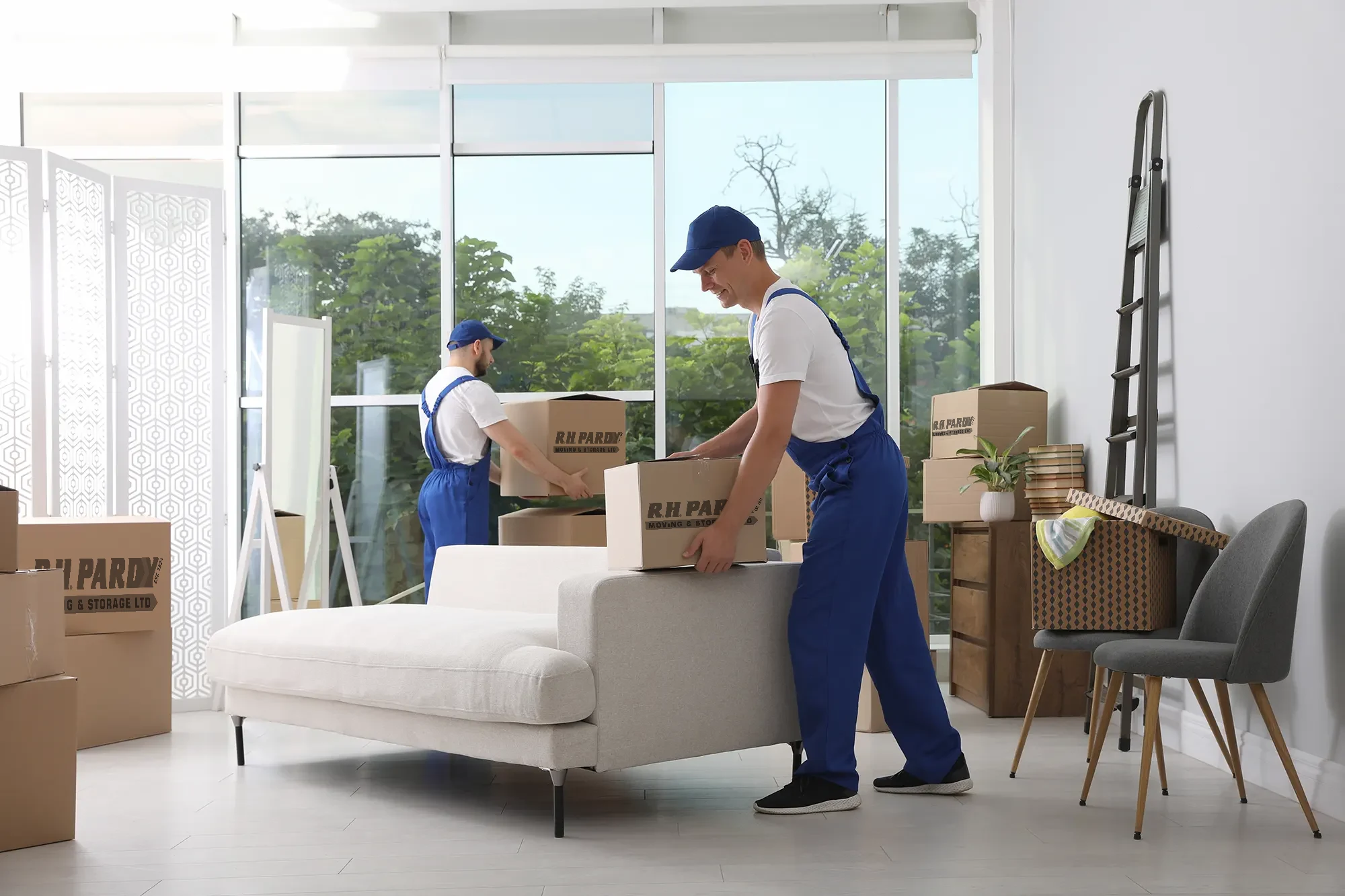 A removals company organizing boxes for the move in a home