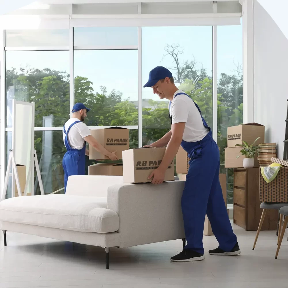 A removals company organizing boxes for the move in a home