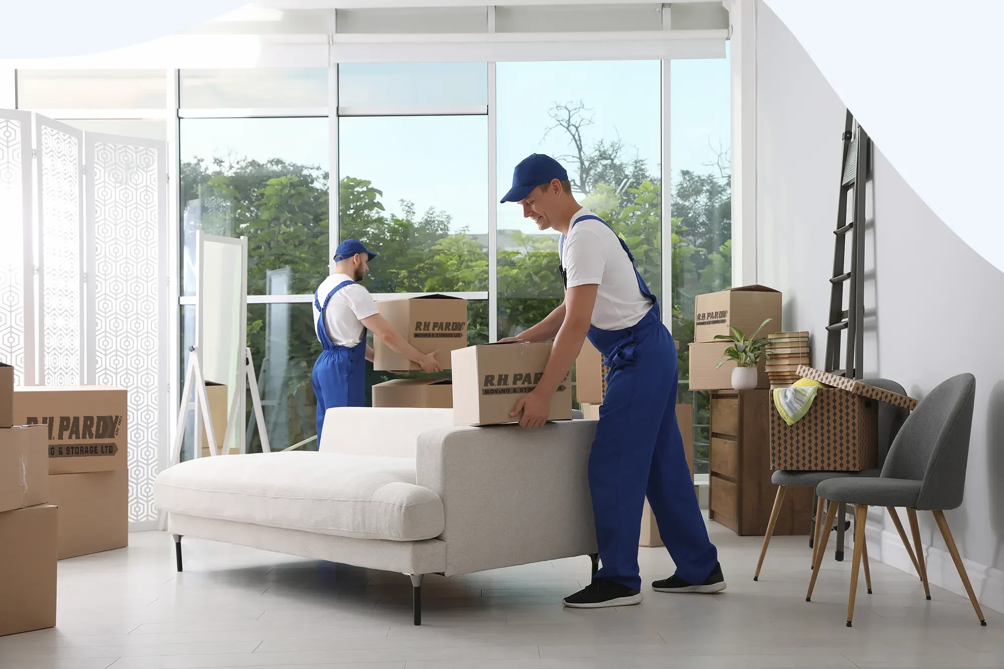 A removals company organizing boxes for the move in a home