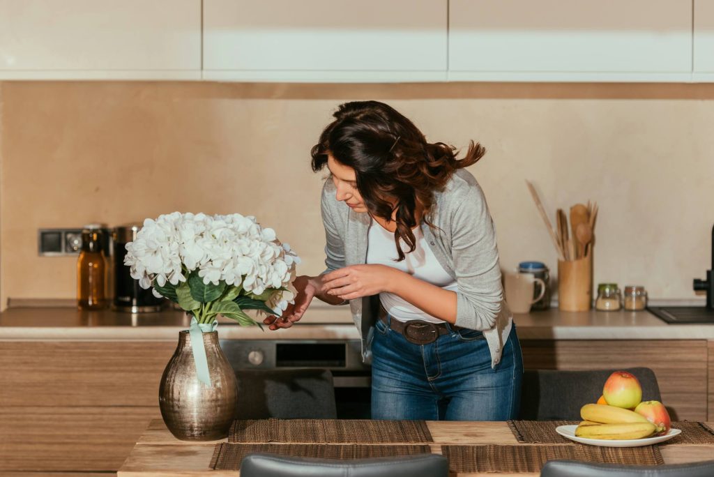 Woman putting flowers in vase